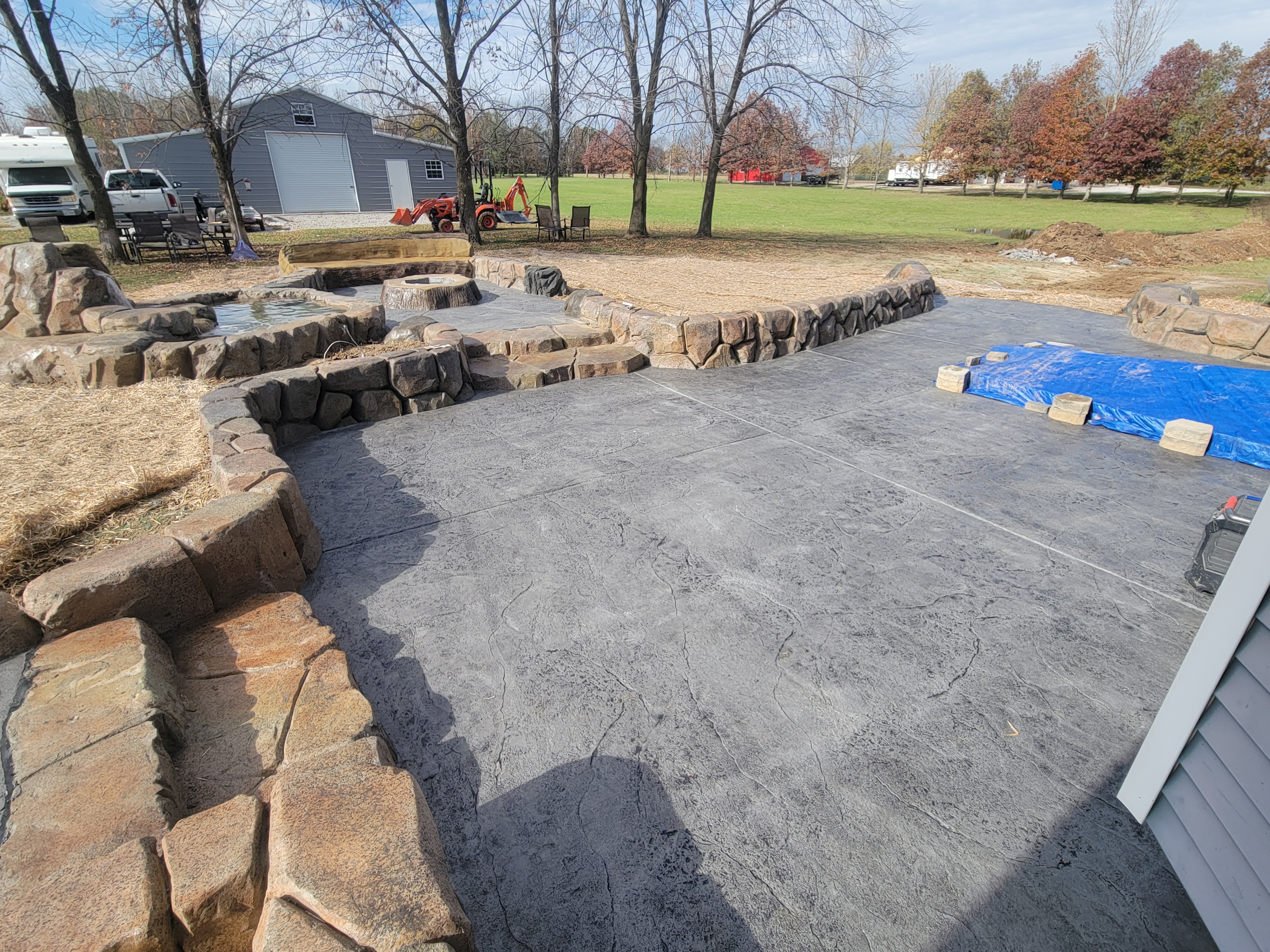 Water feature, fire pit, and patio